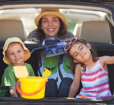 Mother,With,Two,Little,Children,Sitting,In,The,Back,Seat,