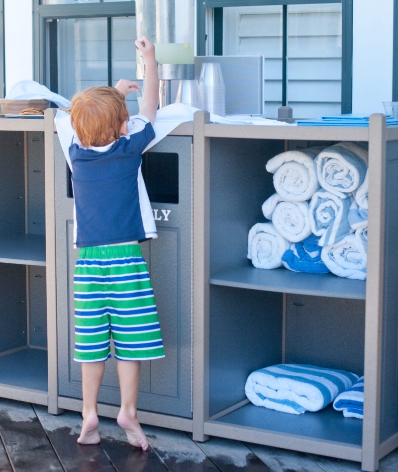 A boy gets ready on a pool patio